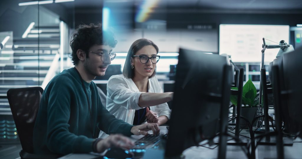 Two professionals looking at a computer screen